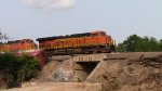 A BNSF freight moves through the derailment site